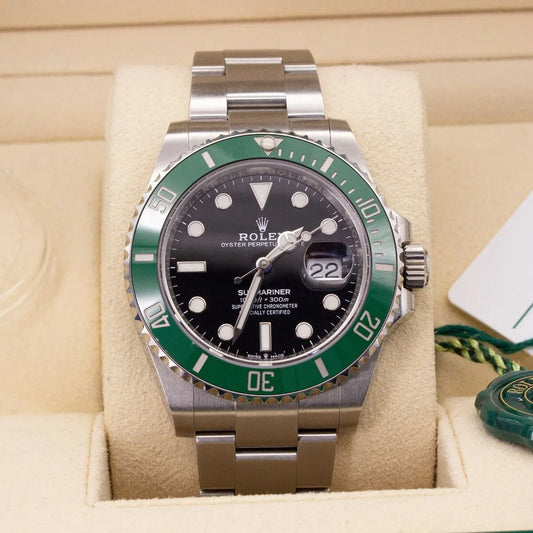 Rolex watch with green bezel and black face on a beige cushion