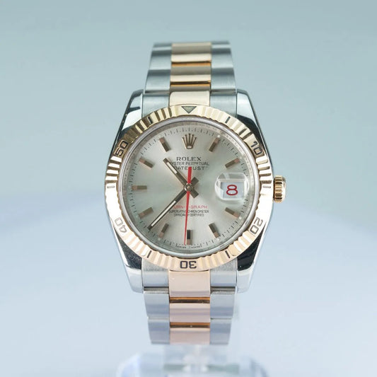 Rolex Datejust 116261 Turn O Graph Luxury watch with silver and gold band on a light blue background