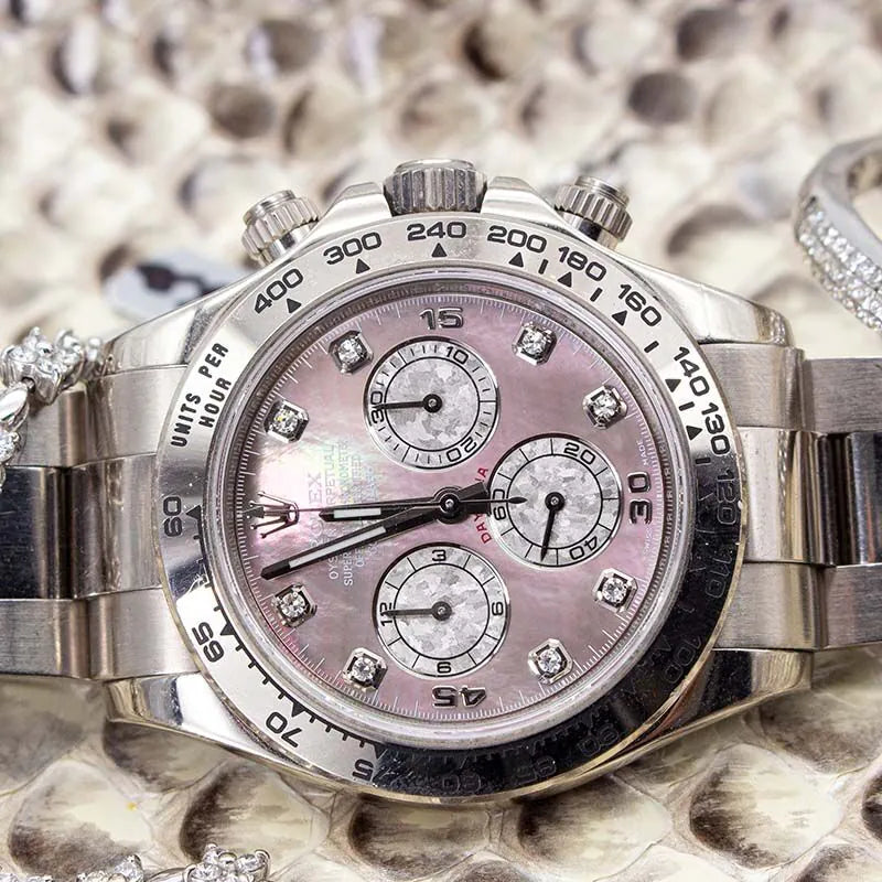 Rolex Daytona 116509 Tahitian Mother of Pearl Dial watch with a pink face and diamond accents on a textured surface