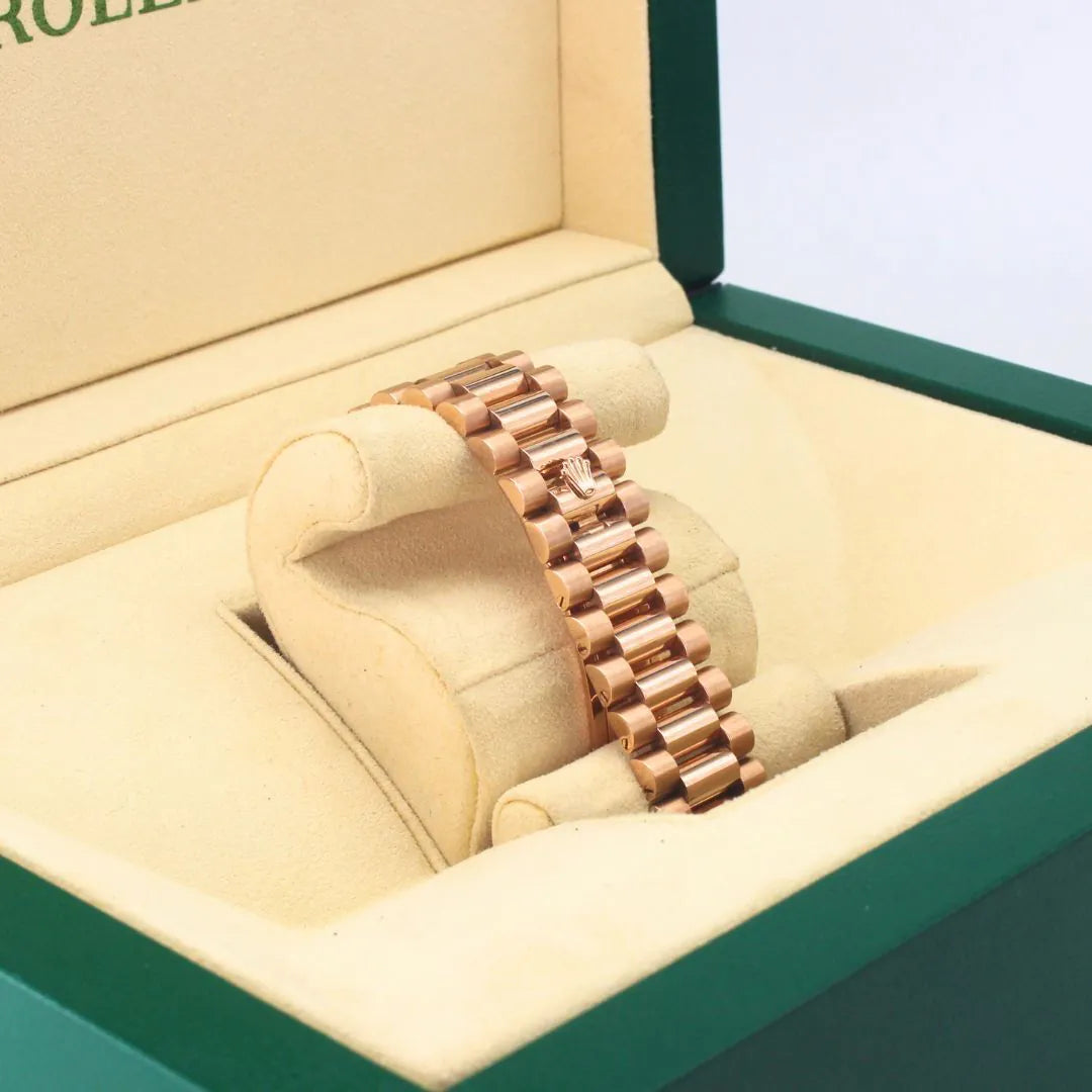 Rolex Day-Date 40 228235 Chocolate Motif Dial 18k Everose Gold Watch Rose gold bracelet in a jewelry box with 'Rolex' branding.