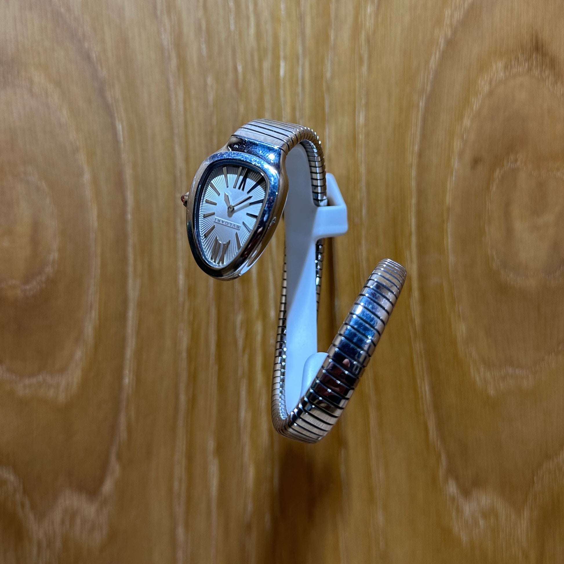 Bvlgari Serpenti Tubogas 101828 – Small 35mm White Dial Stainless Steel Ladies Watch with a white strap on a wooden surface