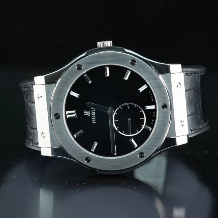 Hublot Classic Fusion Ultra-Thin 515.NX.1270.LR Titanium 45mm Black Dial watch with black face on a reflective surface