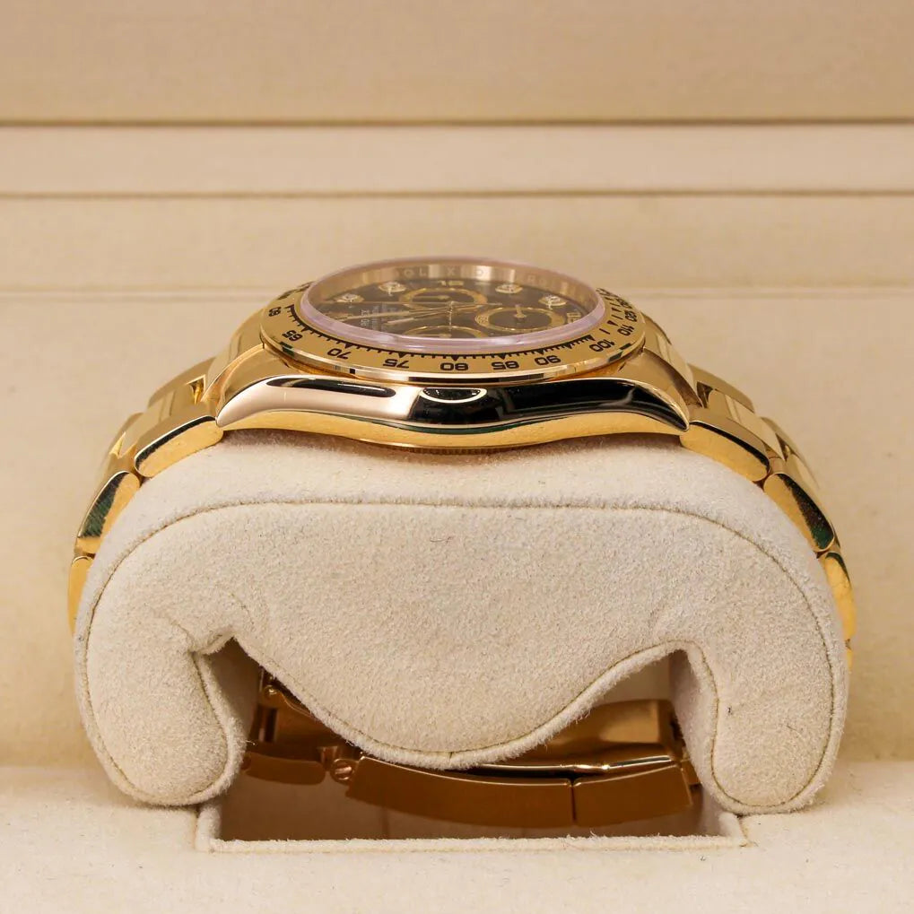 Rolex Cosmograph Daytona 116508 Black Diamond Dial Gold wristwatch on a white cushion with a beige background