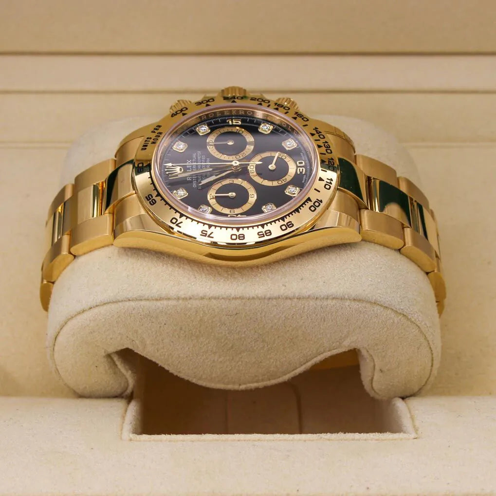 Rolex Cosmograph Daytona 116508 Black Diamond Dial Gold wristwatch with a black face on a beige cushion