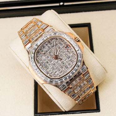 Patek Philippe Nautilus 5711/1R 18K Rose Gold Baguette Diamond Set  Luxury diamond-encrusted watch on a beige cushion with a black background