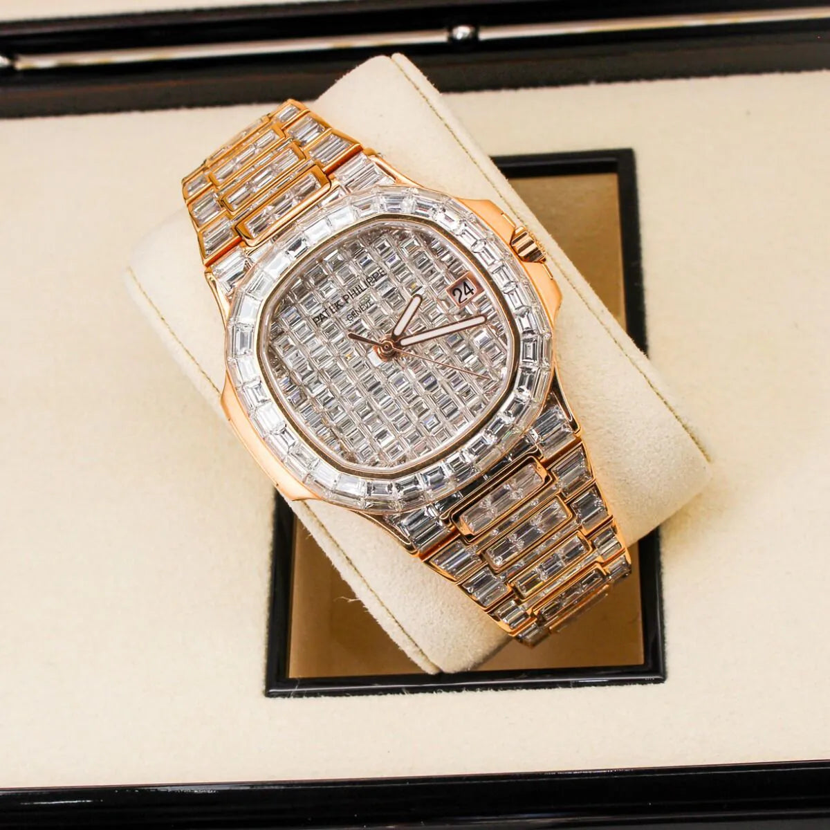 Patek Philippe Nautilus 5711/1R 18K Rose Gold Baguette Diamond Set  Luxury diamond-encrusted watch on a beige cushion with a reflective surface