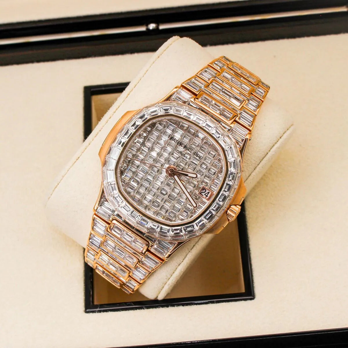 Patek Philippe Nautilus 5711/1R 18K Rose Gold Baguette Diamond Set  Luxury diamond-encrusted watch on a beige cushion with a reflective surface