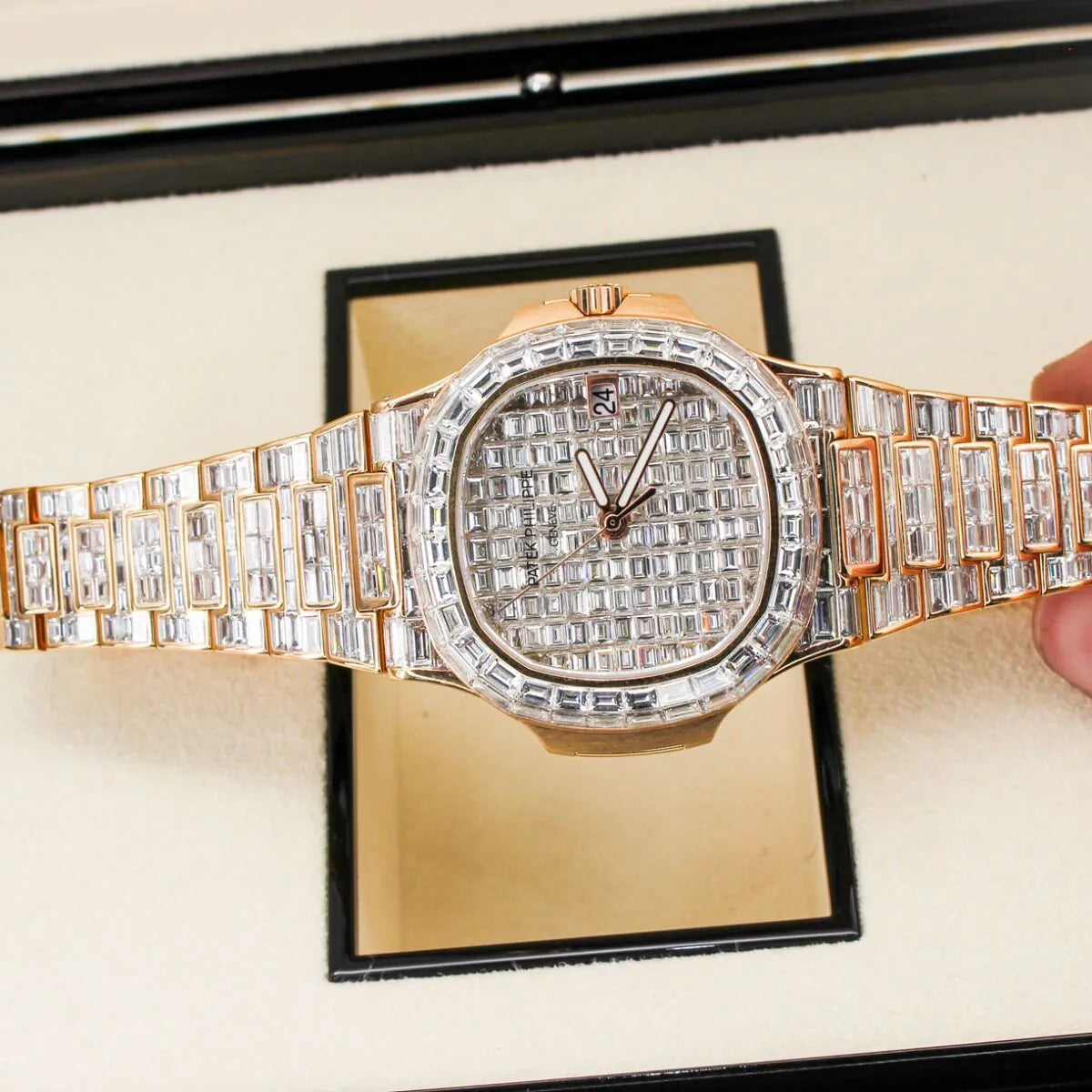 Patek Philippe Nautilus 5711/1R 18K Rose Gold Baguette Diamond Set  Luxury diamond-encrusted watch on a display stand