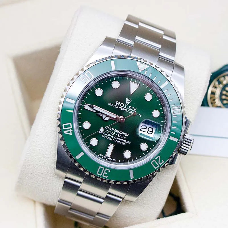 Rolex watch with green bezel and face on a white cushion