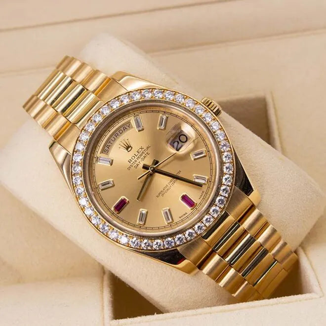 Rolex Day-Date II 218348 18ct Yellow Gold Factory Diamond Bezel & Ruby Dial  Gold wristwatch with diamond bezel on a beige background