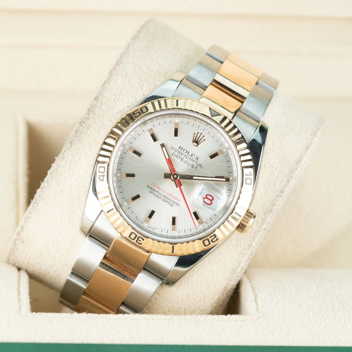 Rolex Datejust 116261 Turn O Graph Two-tone watch with silver and gold straps on a white cushion