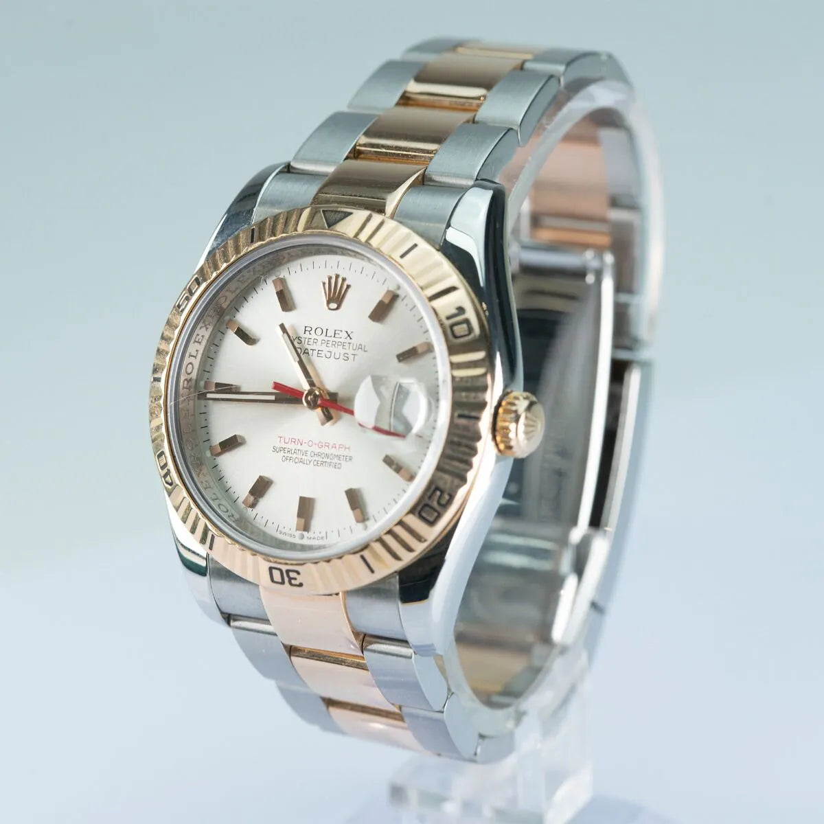 Rolex Datejust 116261 Turn O Graph Two-tone Rolex watch with silver and gold band on a light blue background