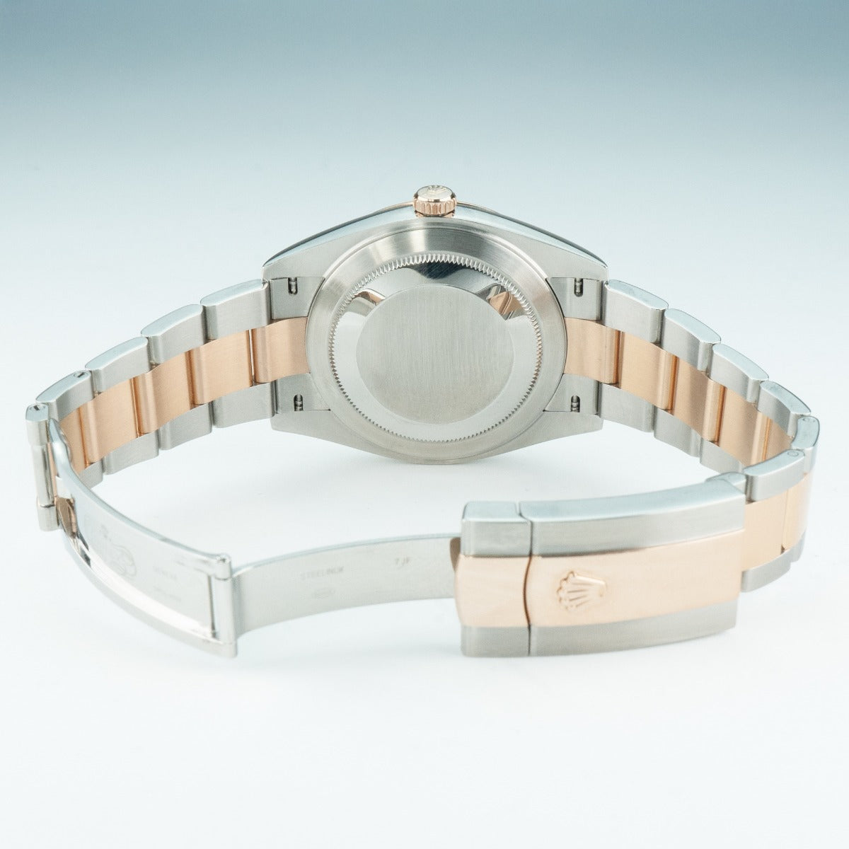 Two-tone watch with silver and rose gold band on a light gray background