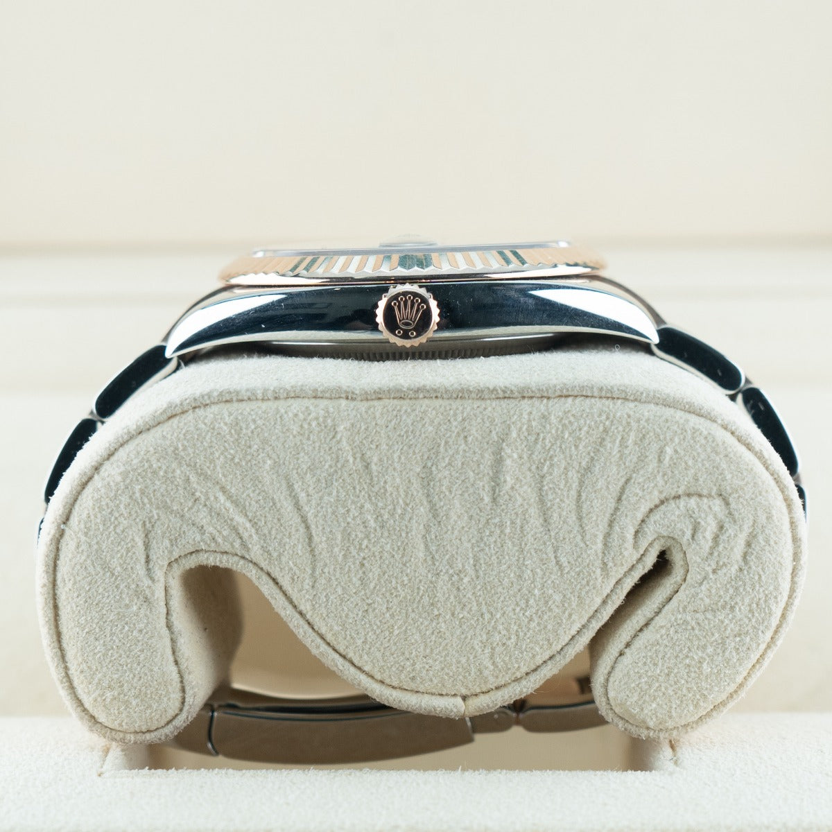 Close-up of a luxury handbag with a visible brand logo on a light background
