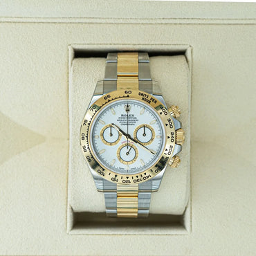 Rolex Daytona 126503 White Dial 18ct Yellow Gold & Steel 2024 Luxury watch with silver and gold band in a box on a beige background