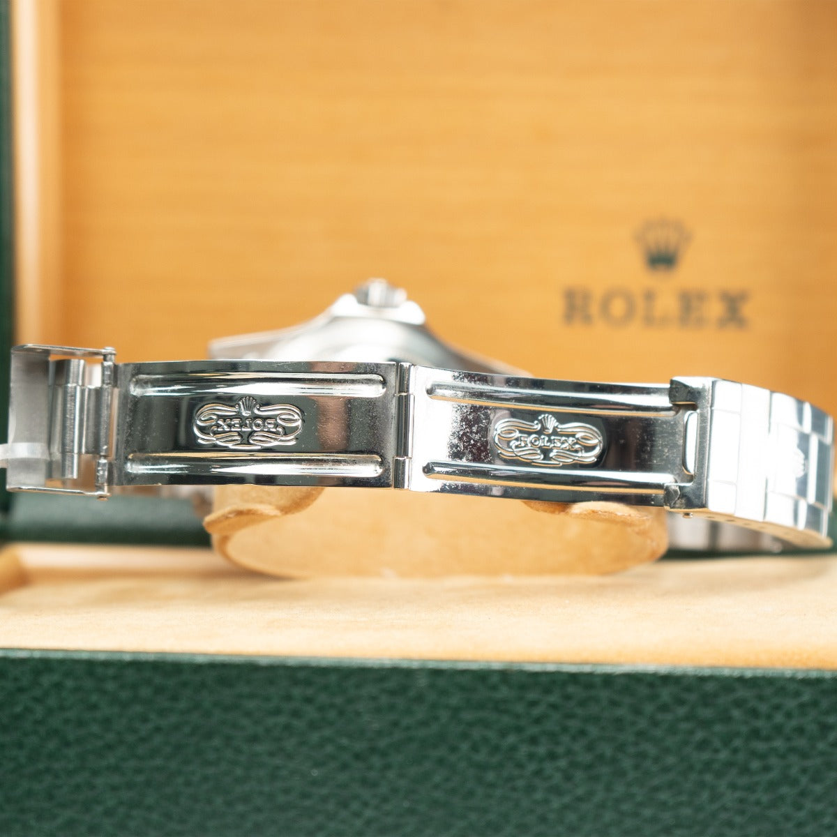 Rolex Submariner 16800 Watch Close-up of a Rolex watch band with a blurred background